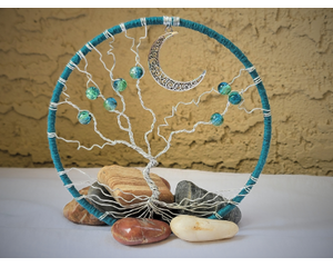 front view showing vignette background letting beautiful blue color hoop stand out standing amongst tumbled stones crescent moon accent 